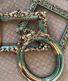 two ornate frames sitting on top of a table