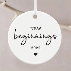 a new beginnings ornament hanging from a string