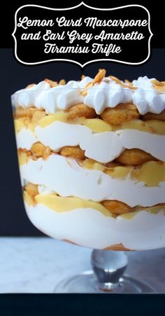 a layered cake with lemon custard and meringue on top, in a trifle dish