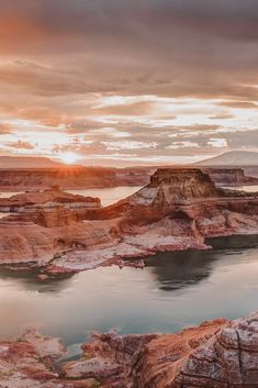 the sun is setting over lake powell in the badlands, arizona state park on a cloudy day