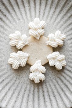 a white plate topped with frosted cookies on top of a table