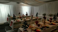 tables set up with christmas decorations and place settings