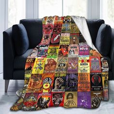 a couch with a blanket covered in posters