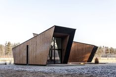 a wooden structure with two large windows on top of it's sides, in the middle