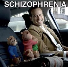 a man sitting in the back seat of a car with stuffed animals on his lap