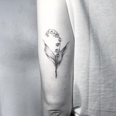 a woman's arm with a flower tattoo on it