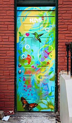 a colorful painted door with a butterfly on it