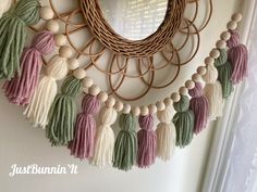 a wreath with tassels hanging on the wall