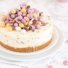 a cake with white frosting topped with lots of candy