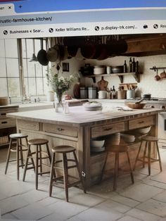 an image of a kitchen with many pots and pans on the island