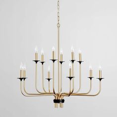 a gold chandelier with black and white candles