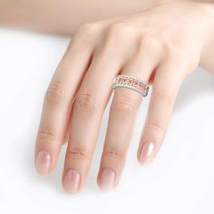 a woman's hand with a ring on it and a pearl in the middle