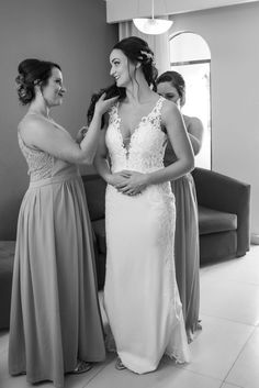 two bridesmaids helping each other get ready for their wedding at the hilton hotel