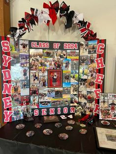 a table topped with pictures and plaques covered in red, white and black ribboned decorations