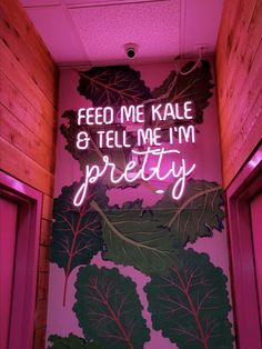 a neon sign that reads feed me kale 8 tell me i'm pretty