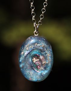 "If you are searching for a truly unique and breathtaking memorial gift, look no further than our milky way pendants! These cremation galaxy necklaces are handcrafted for you with the ashes you provide. Each swirling, shimmery galaxy is set in a 18x25mm oval sterling silver pendant and hangs from your choice of sterling silver chain. These galactic necklaces are built in layers to give them as much depth as possible. In the comments box, please note how defined you would like the \"swirl\" to be Veteran Husband, Cremation Jewelry Necklaces, Jewelry For Ashes, Ash Jewelry, Memorial Jewelry Ashes, Galaxy Necklace, Dog Remembrance, Ashes Necklace, Cremation Necklaces