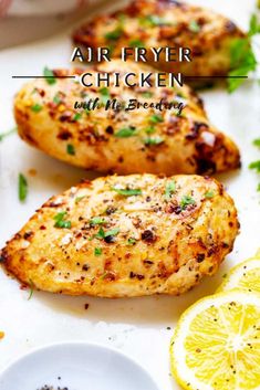 air fryer chicken with herbs and lemons on the side