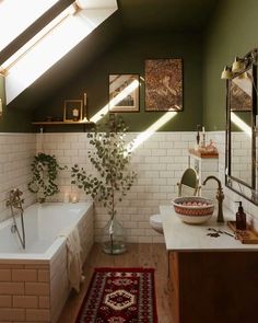 a bath room with a tub a sink and a rug