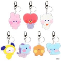 six different shaped key chains with cartoon characters on them, all in various colors and shapes