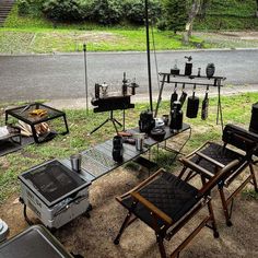 an outdoor grill and chairs set up on the side of the road for barbecues