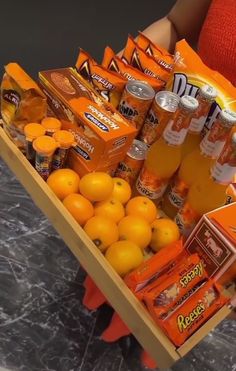 a person holding a cart full of orange juice