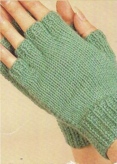 a woman's hand wearing a green knitted mitt with two fingers on it