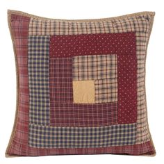 a red and black plaid pillow with a square patch on the front, one side