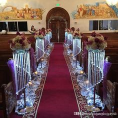 the aisle is decorated with candles and flowers