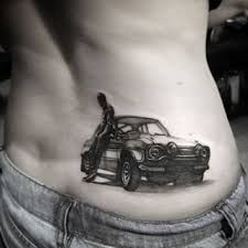 a man with a car tattoo on his stomach