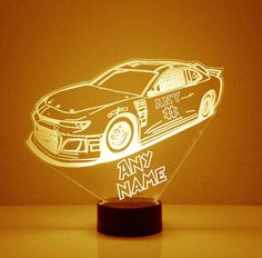 a car shaped lamp with the words any name on it and an image of a car