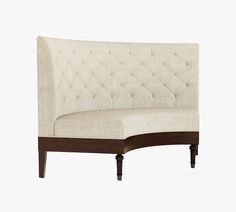 an upholstered couch with wooden legs and buttoned backrests, on a white background