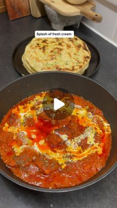 two pans filled with food sitting on top of a counter next to each other