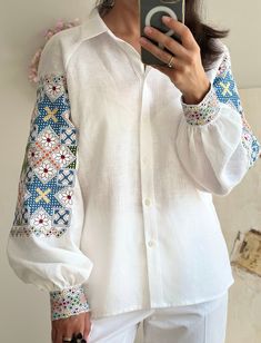 White linen blouse with bright color embroidery. Folk cultural embroidery. Fashion embroidered garment. Natural superb fabric and generous embroidery. Beautiful garment. It is very difficult to convey the real beauty of the embroidery, the glow and the iridescence of the threads in the photo. Delivery usually takes up to 1-2 weeks in total, this includes 3-7 days for production and 3-7 days for shipping to Europe and to the USA. We use FeDex and UPS express shipping. Returns and Exchanges We gla Sleeve Embroidery, Traditional White Top With Geometric Embroidery, Folk Style White Blouse With Intricate Embroidery, White Folk Tops With Geometric Embroidery, White Folk Blouse With Intricate Embroidery, White Embroidered Top With Geometric Design, Short Sleeve, White Linen Blouse, Folk Fashion, Linen Blouse