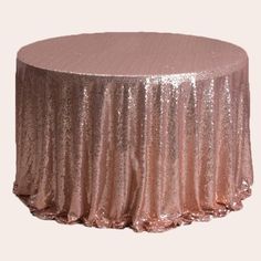 a rose gold sequin tablecloth on a white background