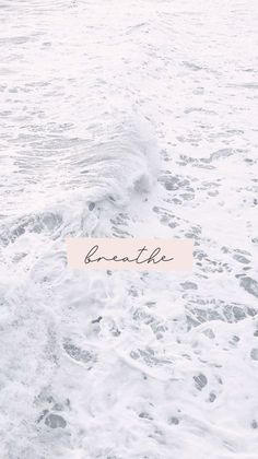 the word breathe is written on a piece of paper in the ocean foamy water