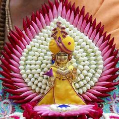 the statue is decorated with red and white flowers