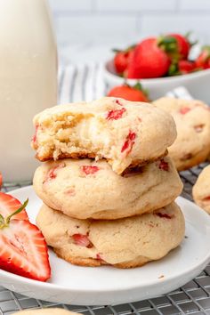 strawberry shortbread cookies stacked on top of each other with strawberries in the background