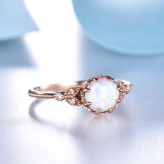 a white opal ring sitting on top of a table