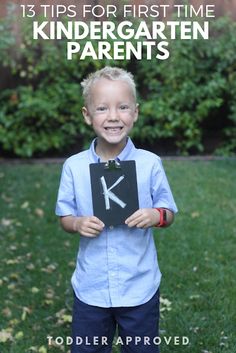 a young boy holding up a sign that says tips for first time kindergartn parents