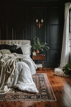 a bedroom with black walls and wooden floors