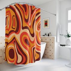 an orange and red shower curtain in a bathroom