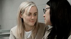 two women sitting next to each other in front of a mirror looking at each other