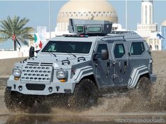 an armored vehicle driving through the mud