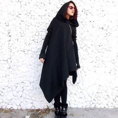 Asymmetric extravagant black coat. Extra Long Wool jersey Sleeves and Wool Jersey Hood. No lining Extravagant and Unique Black Asymmetrical Coat With Zip in front. Comfortable and always in Style!   Material: 50% cotton 50% acryl  Care instructions: Wash at 30 degrees.  The model in the picture is size S. Can be made in ALL SIZES. If you have any other specific requirements, do not hesitate to contact me! I DO NOT CHARGE EXTRA MONEY for custom made items. All you need to do is send me your me... Cyberpunk Black Hooded Jacket For Fall, Black Cyberpunk Hooded Jacket For Fall, Cyberpunk Long Sleeve Hooded Jacket For Fall, Winter Techwear For Cosplay, Winter Techwear Outerwear For Cosplay, Cyberpunk Long Sleeve Winter Outerwear, Cyberpunk Outerwear With Detachable Hood For Fall, Alternative Oversized Winter Outerwear, Cosplay Winter Outerwear With Adjustable Hood