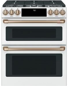 two white and gold ovens side by side