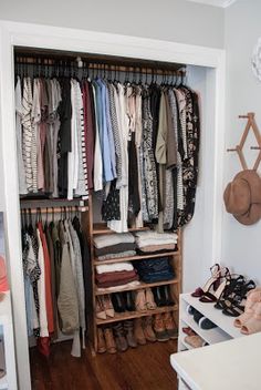 an organized closet with clothes and shoes