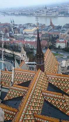 an aerial view of the roof of a building, with a large body of water in the background