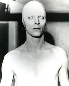 a black and white photo of an alien man