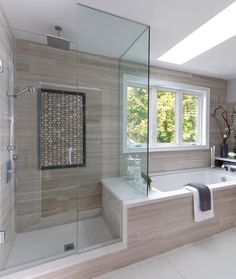 a bathroom with a tub, sink and shower in it's center wall is shown