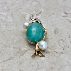 "Fine vintage 14 karat yellow gold jadeite and pearl pendant necklace. It features a large natural green jadeite jade weighing approximately 17 carats and two white pearls measuring 6-7 mm. The pendant is stamped 14K Hong Kong. It weighs 7.8 grams. L: 1.87\" W: 0.85\" Birthstone: June. Condition: Very Good. - 14 day return policy, no questions asked. - Free insured shipping in the US. - International shipping available. Visit our website for more details about our company: www.weiljewelry.com" Vintage Jade Jewelry For Anniversary, Oval Jade Necklace For Anniversary, Antique Jade Jewelry For Anniversary, Green Cabochon Necklace For Anniversary, Anniversary Yellow Gold Chrysoprase Jewelry, Chrysoprase Jewelry For Anniversary And May Birthstone, Emerald Eternity Band, Chinese Jewelry, Pearl Pendant Necklace